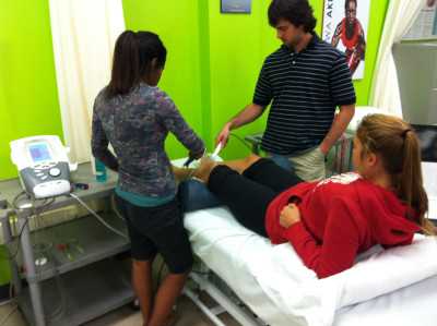 Nadia, fourth year Athletic Therapy student, gives a patient an ultrasound on her ankle. 