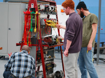 Students check wires before proceeding with work