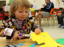  Susanna Kostelansky, 2, focusing on cutting up pieces for her art activity. (Photography by Courtney Blok / The Sheridan Sun)