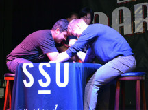 On the stage at the Marquee, Abdullah Saleh and Devin Rintoul, compete in the first arm wrestling match at Healthy Heart Day. 