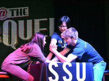 Sheridan Student Union employees Fawzia Hasan, senior manager in services and Christopher Berwick, executive vice president of Trafalgar, get ready to arm wrestle at the Marquee. 