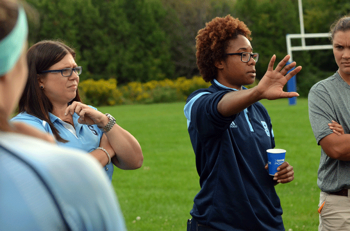On the right is Bruins assistant coach Amanda Corsetti and on the left, head coach Tamara Dixon speaking to the team prior to a game last season. 