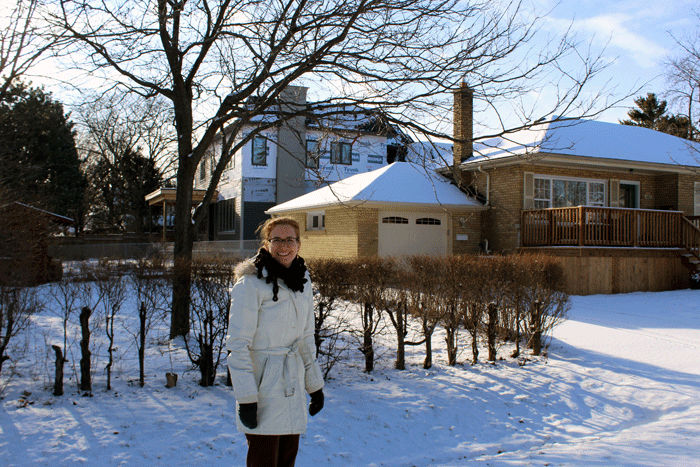 Linda Morgan is standing in front of neighbour Frank Seviour's home. The new dwelling is towering above his home. 